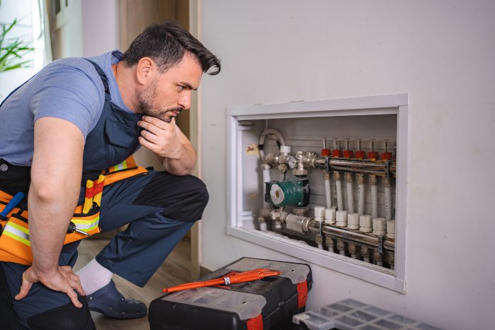 Technician inspecting residential heating system for common issues in Seattle, WA
