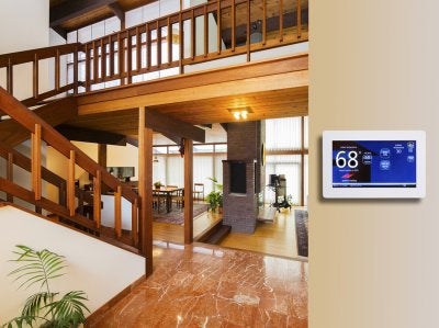 Wall-mounted thermostat control monitor by Olson Energy Services in Seattle, WA